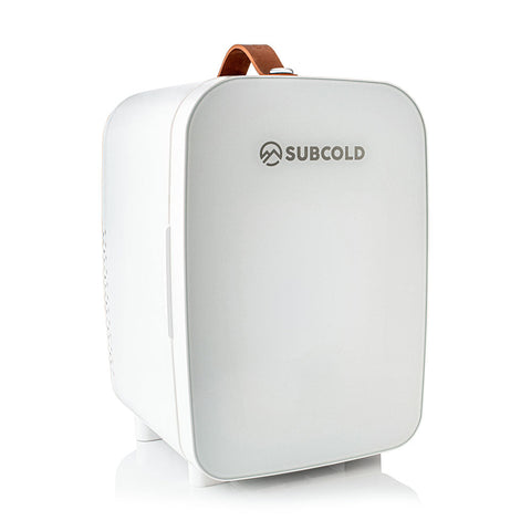 White subcold pro 10l mini fridge with brown leather handle and sleek rounded design perfect for small spaces