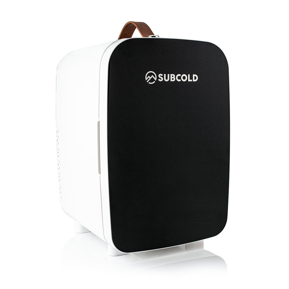 Black and white subcold pro 15l mini fridge with a brown leather handle perfect for small spaces
