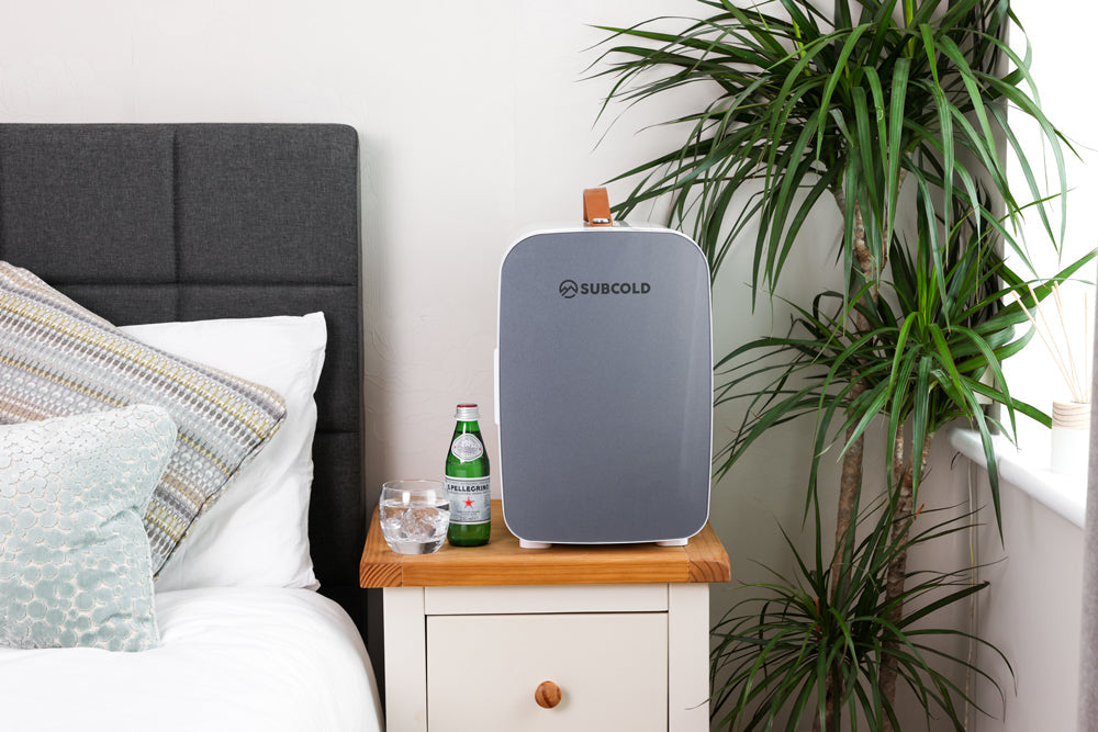 Gray subcold pro 15l mini fridge with wooden handle on bedside table perfect compact 15l mini fridge for small spaces