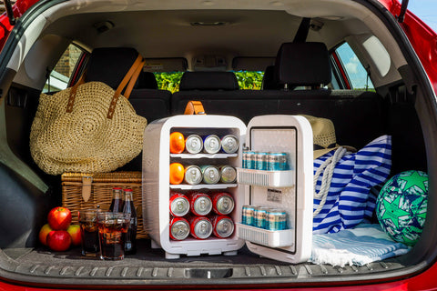 White compact pro 15l mini fridge with open doors showing shelves stocked with soda cans and oranges