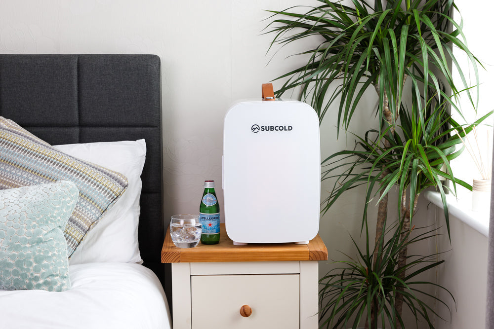 White subcold pro 15l mini fridge with tan leather handle and sleek rounded design portable and stylish 15l mini fridge