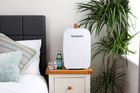 White subcold pro 15l mini fridge with tan leather handle and sleek rounded design portable and stylish 15l mini fridge