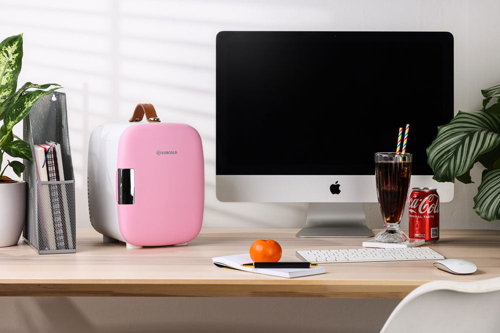 Pink and white Subcold Pro 4L mini fridge with a brown leather handle compact and stylish mini fridge