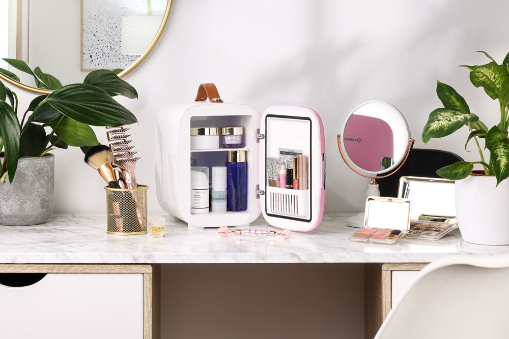 Pink and white subcold pro 4l mini fridge with brown leather handle designed for storing cosmetics