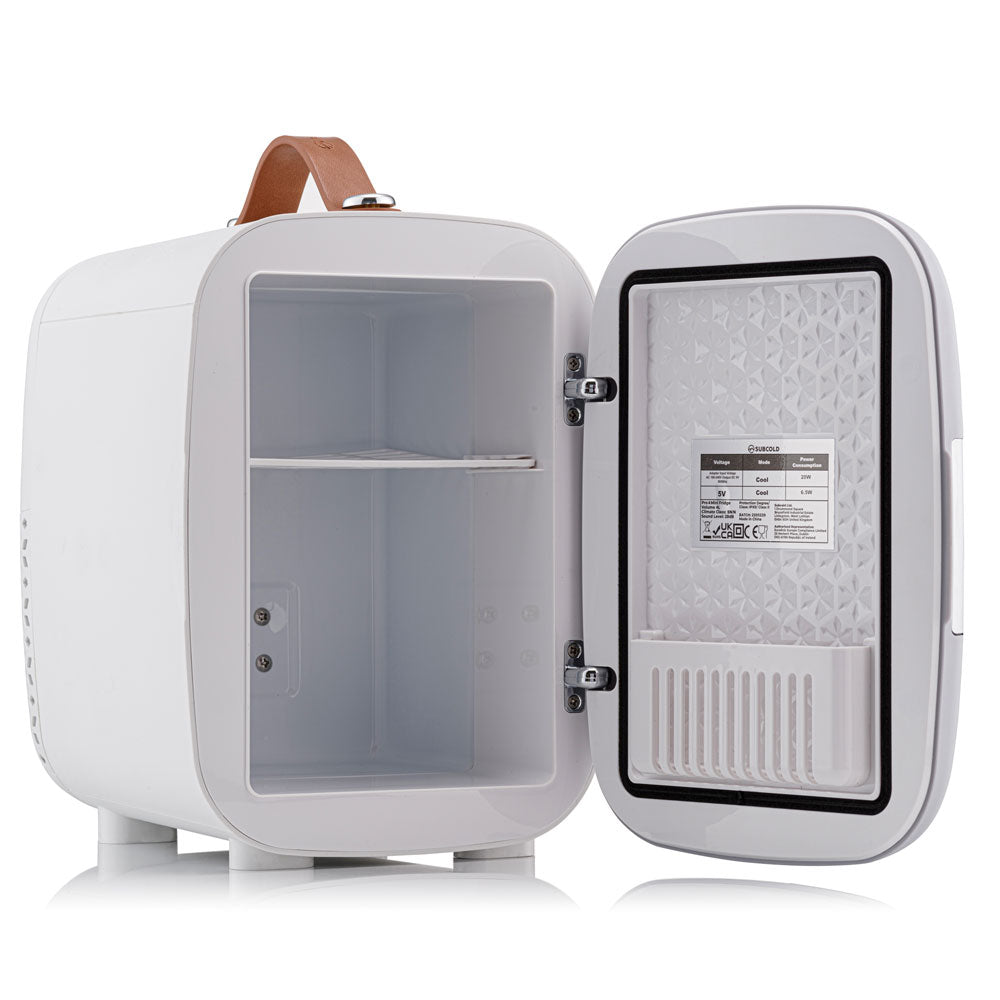 White subcold pro 4l mini fridge with brown leather handle and interior shelves perfect for compact storage