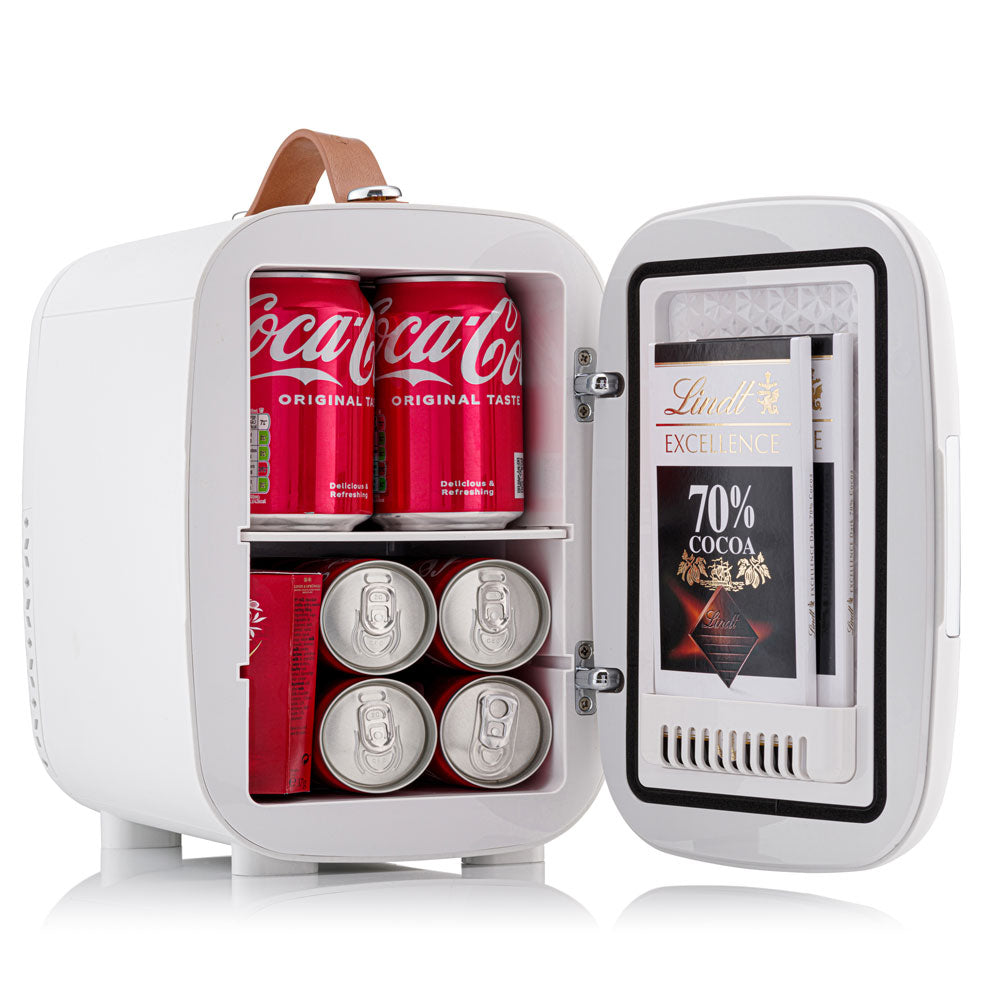 White subcold pro 4l mini fridge with brown leather handle and shelves holding coca-cola cans and lindt chocolate bars