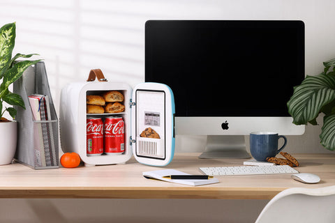White and light blue pro 4l mini fridge with brown leather handle holding coca cola cans and golden pastries