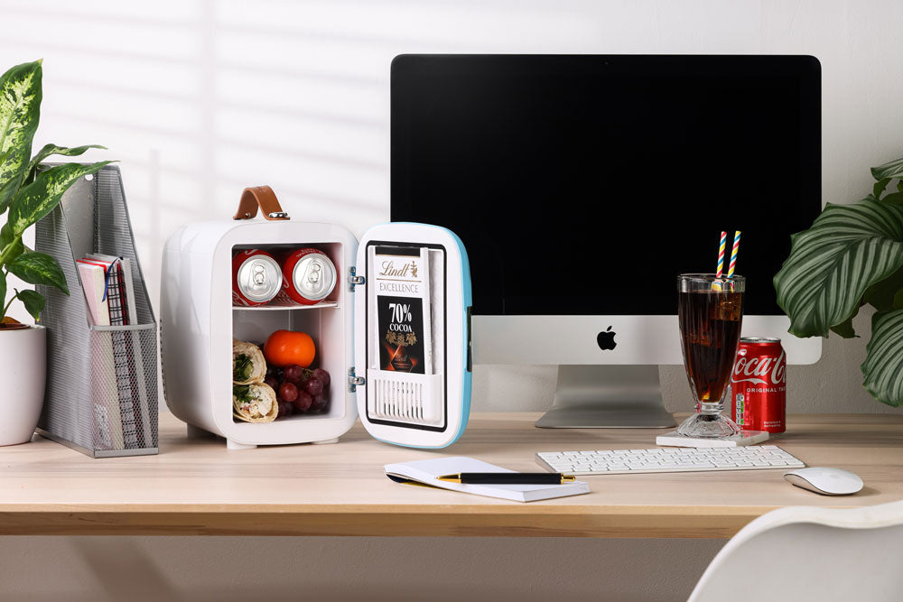 Subcold pro 4l mini fridge in white and light blue with brown leather handle open showing drinks and fruit inside