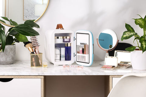 White and light blue subcold pro 4l mini fridge with brown leather handle designed for storing cosmetics