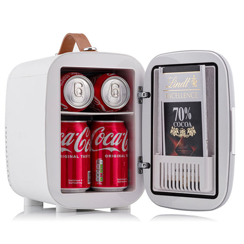 White portable subcold pro 4l mini fridge with brown leather handle and shelves holding coca-cola cans and lindt chocolate