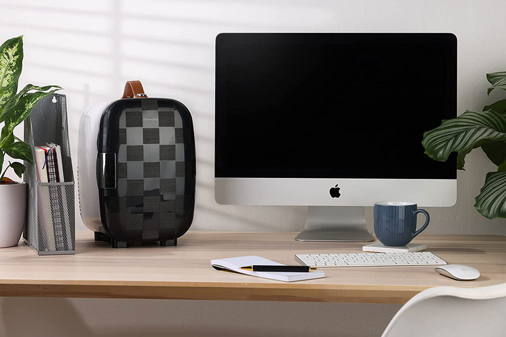 Subcold Pro 6L mini fridge in black and gray checkered design with brown leather handle and removable shelf for larger items