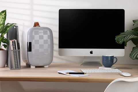 Subcold Pro 6L mini fridge in gray checkered with brown leather handle white feet and removable shelf for larger items