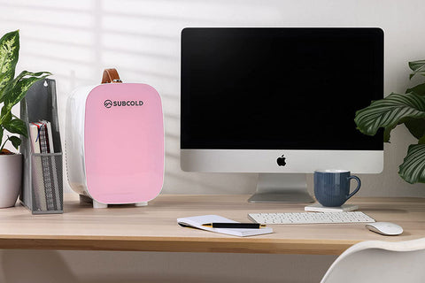 Pink subcold pro 6l mini fridge with brown leather handle white base and removable shelf for larger items storage