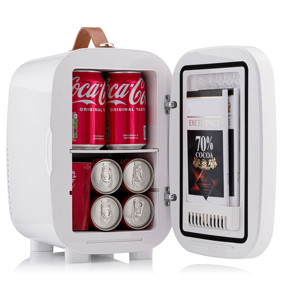 White subcold pro 6l mini fridge with brown leather handle and removable shelf stores coca cola cans and larger items