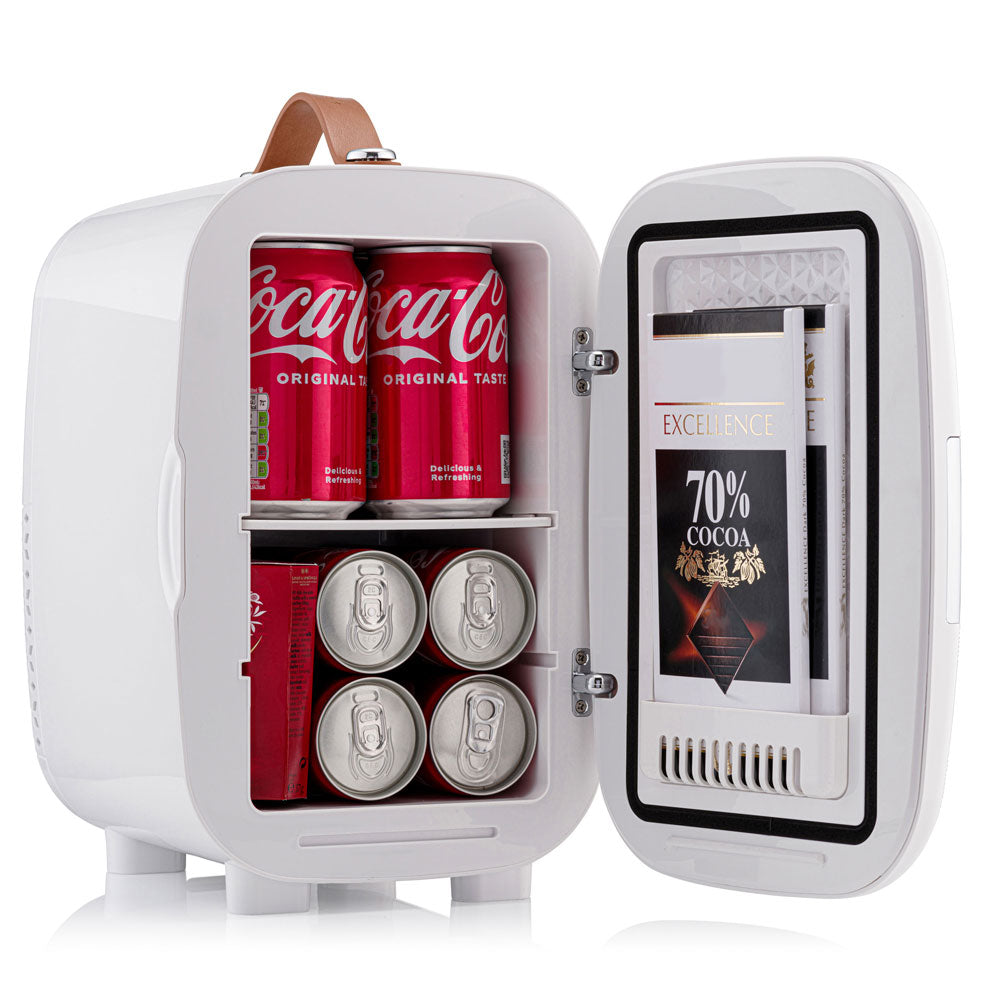 White subcold pro 6l mini fridge with tan leather handle and removable shelf holding coke cans and chocolate bars for larger items