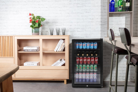 Black glass-door subcold super led beer fridge filled with assorted cans and bottles for beverage storage