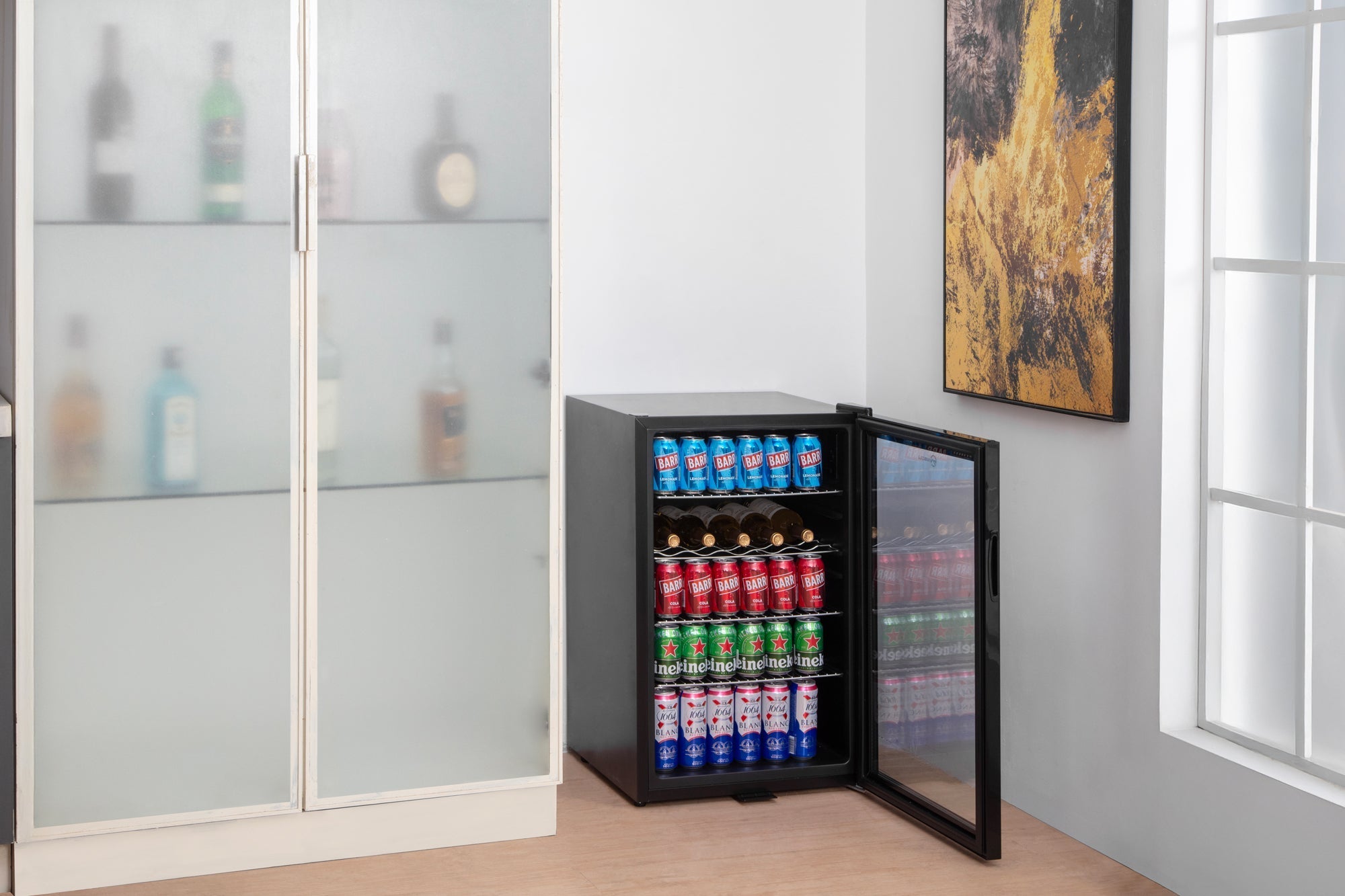 Black subcold super115 led beer fridge with glass door and shelves stocked with colorful sodas and wine bottles