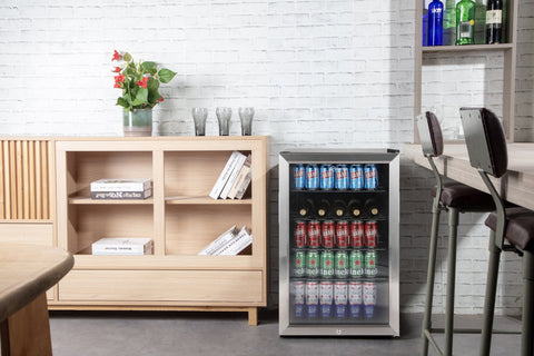 Silver-framed subcold super115 led beer fridge with glass door stocked with cans and bottles for easy access