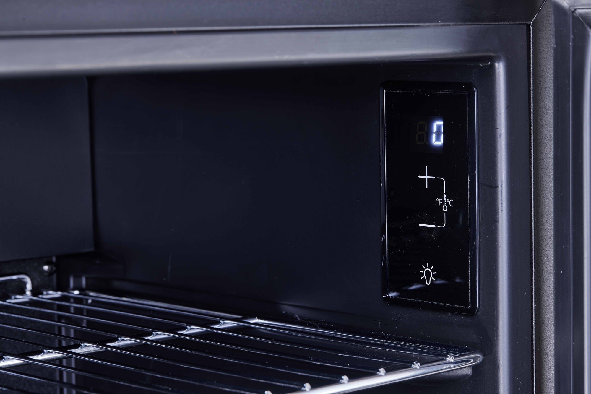 Black digital control panel with illuminated display and temperature buttons on subcold super85 led beer fridge