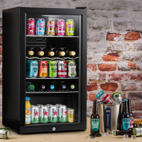 Black glass-door subcold super85 led beer fridge with multiple shelves holding assorted cans and bottles