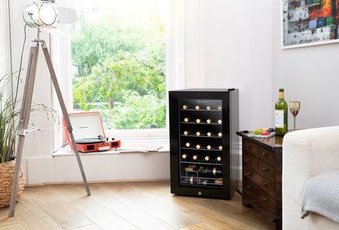 Black glass-door subcold viva24 led wine cooler with multiple shelves holding wine bottles for home use