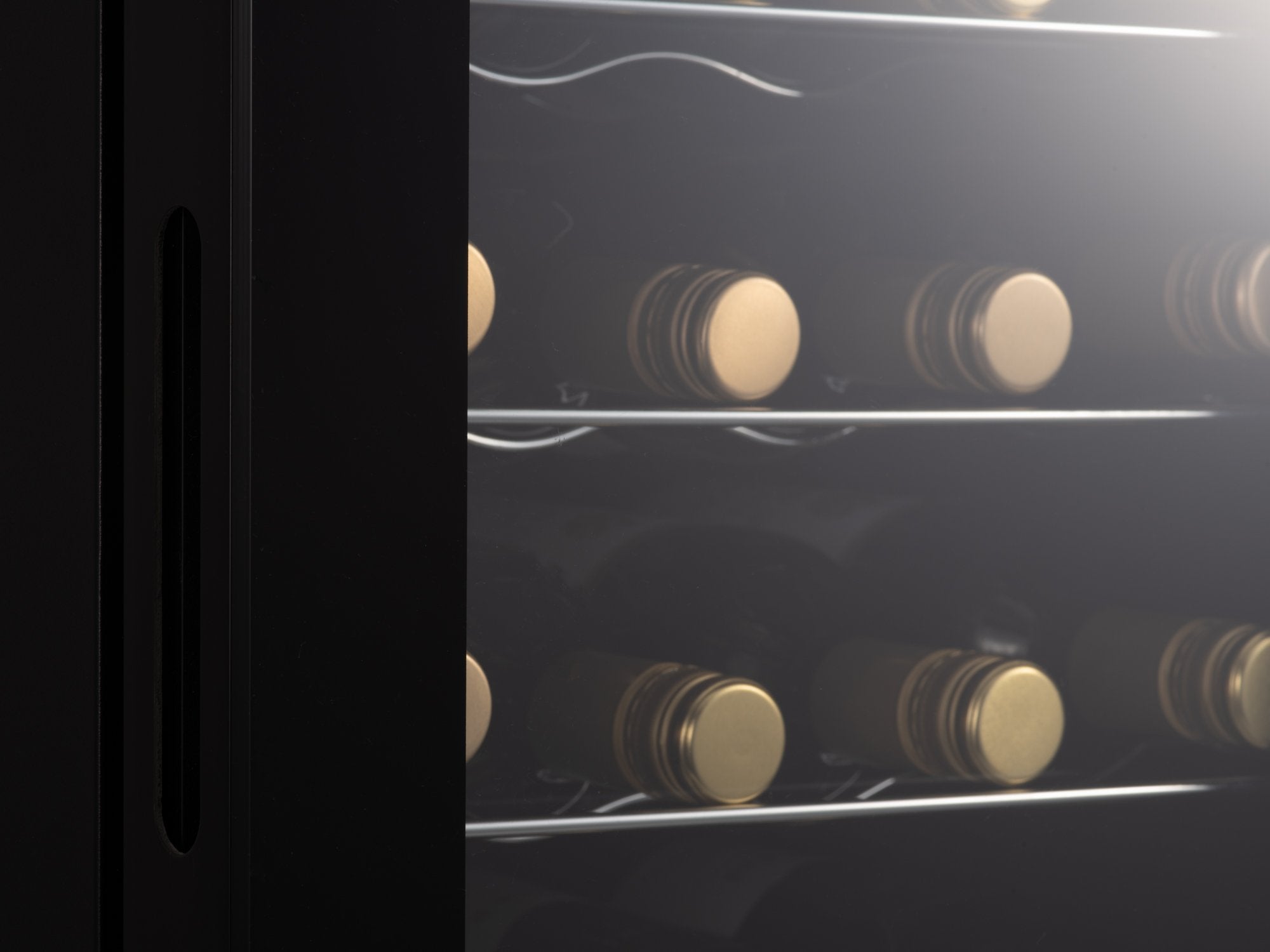 Black subcold viva24 led wine cooler with glass doors showcasing rows of bottles with gold-colored corks