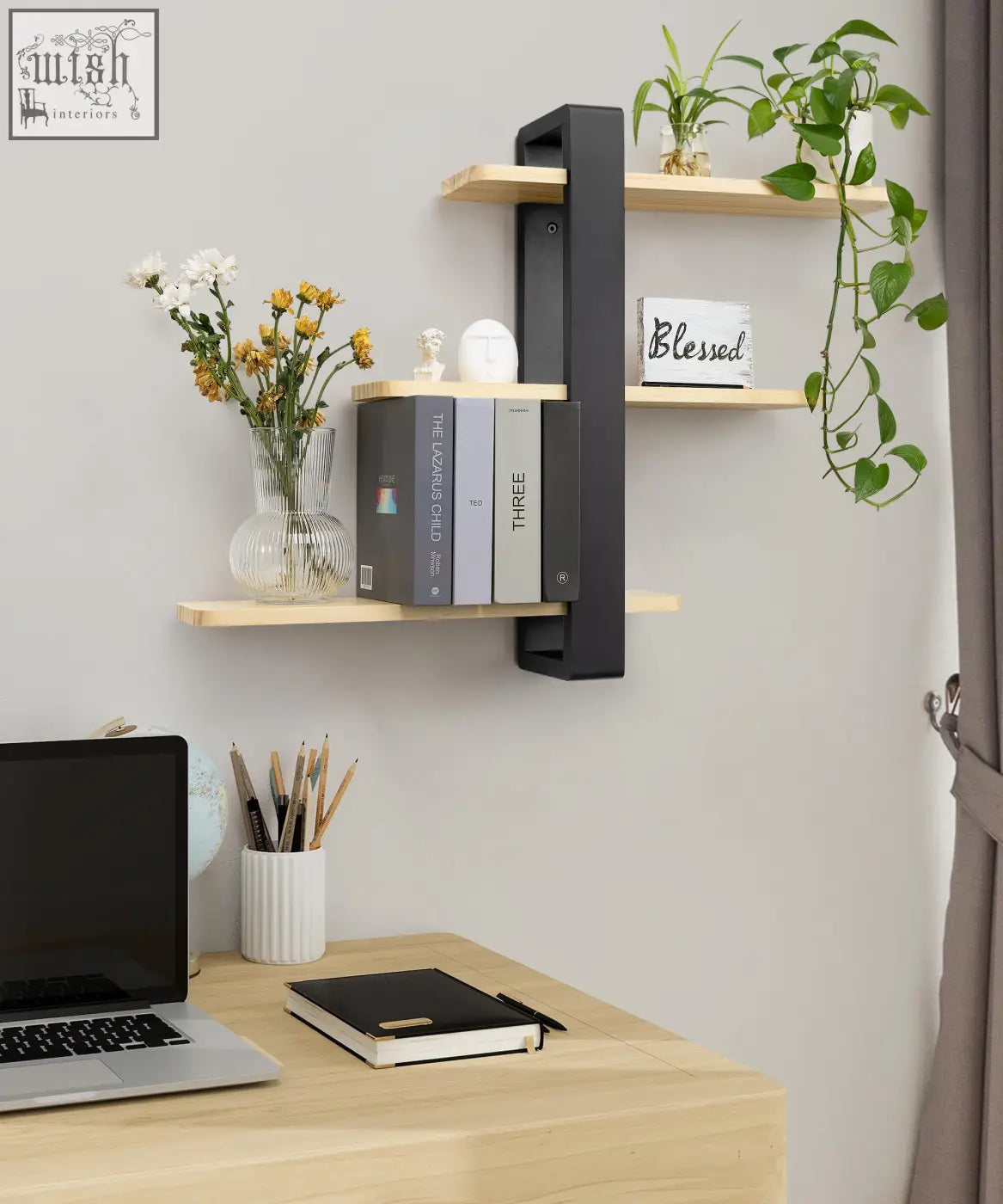 Modern black and light wood pine floating shelves with three tiers holding books and decor for living room shelving unit