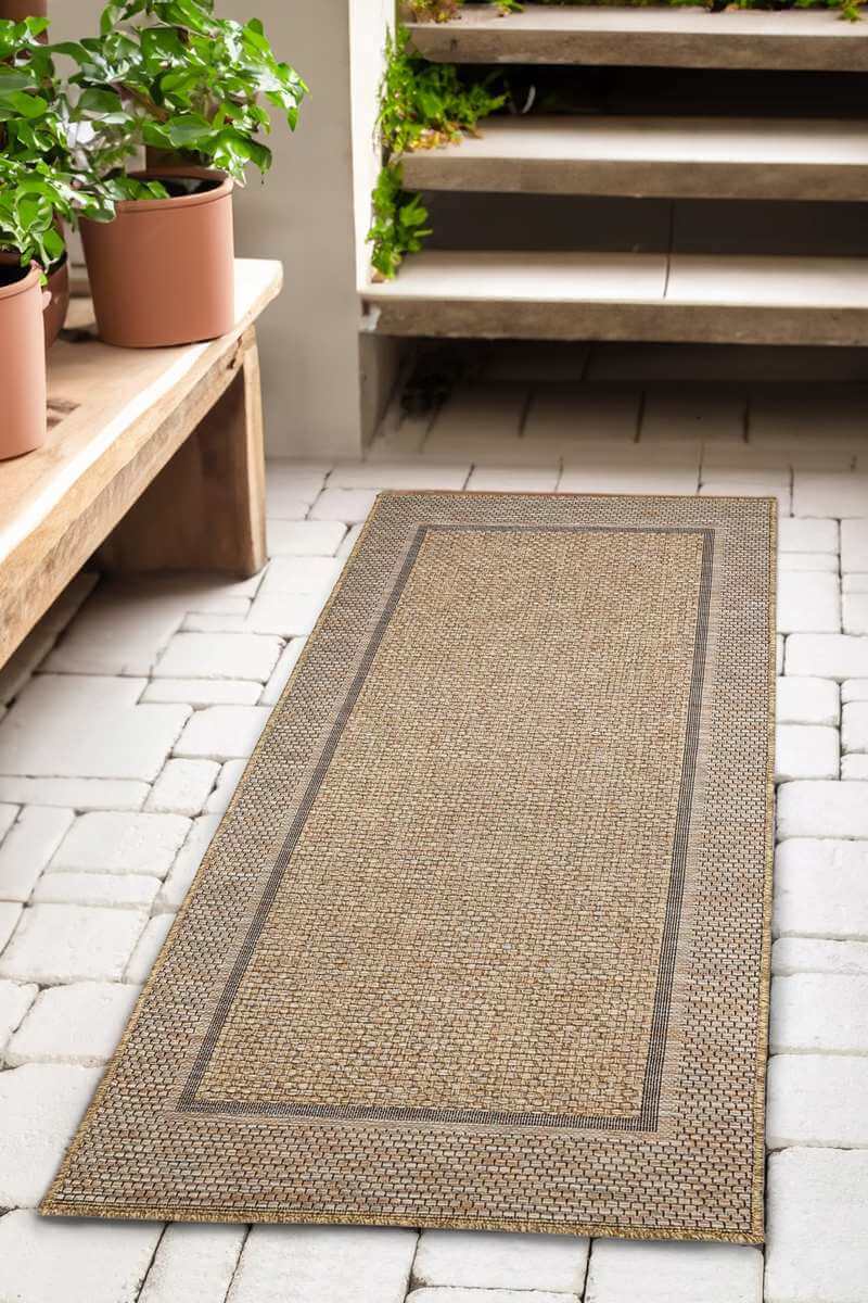 Beige woven summer latte border rug with a central rectangular border perfect for indoor outdoor use