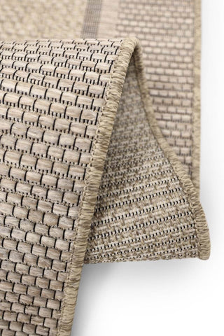 Beige woven summer latte border outdoor rug with textured interlaced pattern and reinforced edge stitching