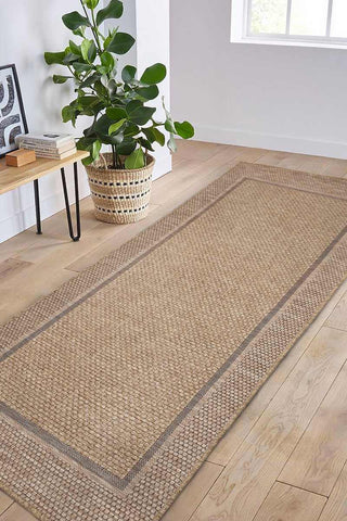 Beige woven summer latte border rug with subtle geometric pattern and dark brown border for indoor outdoor use