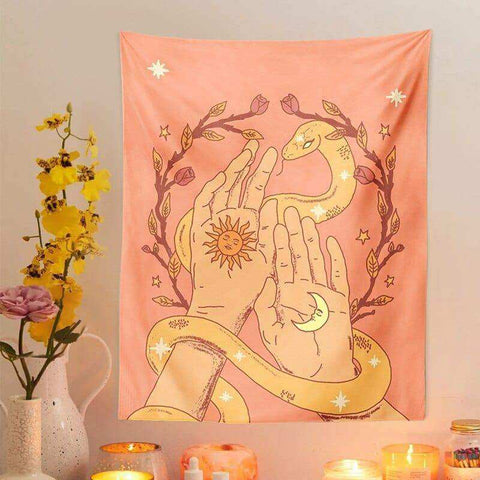 A soft peach moon tapestry with illustrated hands, sun and moon, golden snake, branches, and stars design
