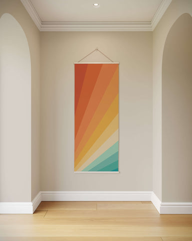 A vertical sunbeam tapestry wall hanging with vibrant orange yellow and teal rays radiating from the bottom