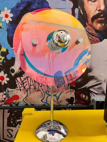 Vibrant translucent pink and orange sunset table lamp with chrome spherical bulb holder and base perfect for any table lamp setup