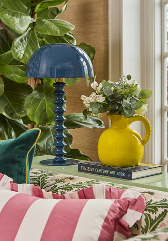 A glossy cobalt blue dome table lamp with a twisted base shown alongside the handcrafted yellow jug sunshine stoneware