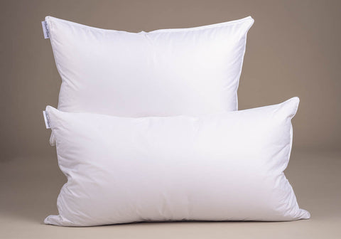 Two white rectangular pillows with smooth fabric covers and small tags featuring siberian goose down filling