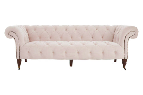 A blush pink tufted velvet blossom fabric chesterfield sofa with rolled arms and larch wood legs