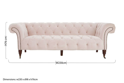 Cream-colored blossom fabric chesterfield sofa with tufted velvet, rolled arms, and dark larch wood legs