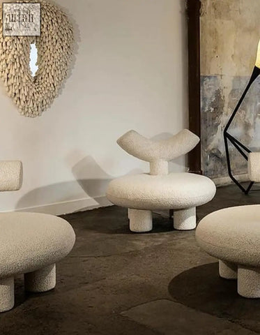Cream-colored plush cloud-shaped stools with rounded bases in cashmere wool for shapte sheep armchair collection