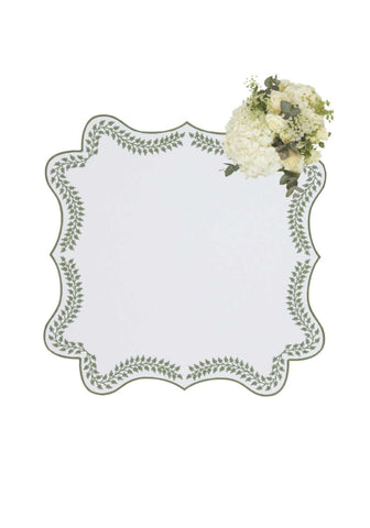A white rectangular mirror with a scalloped edge decorated with an intricate green wreath pattern like green wreath placemats