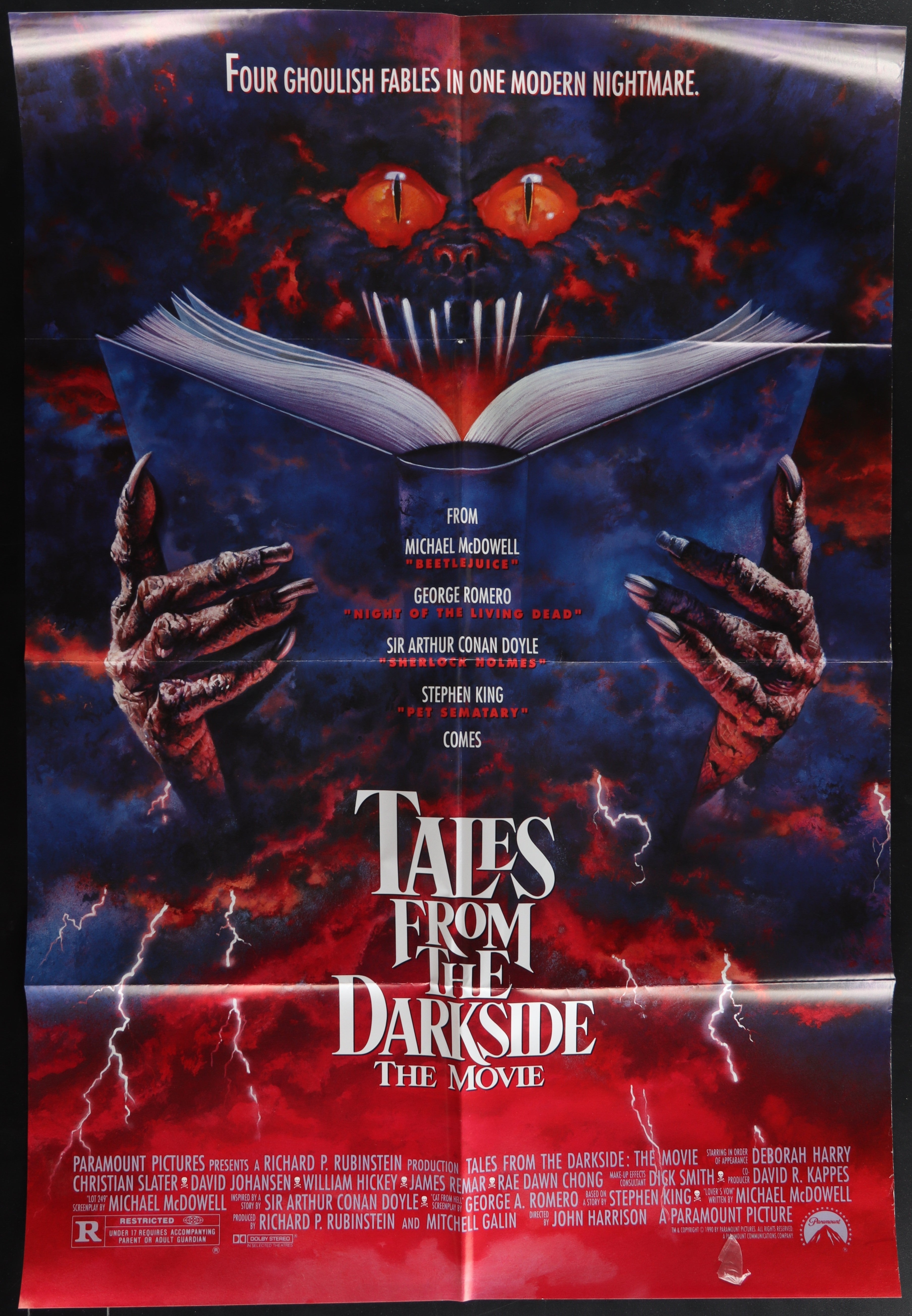 Dark ominous movie poster for tales from the darkside the movie featuring a menacing face with glowing red eyes