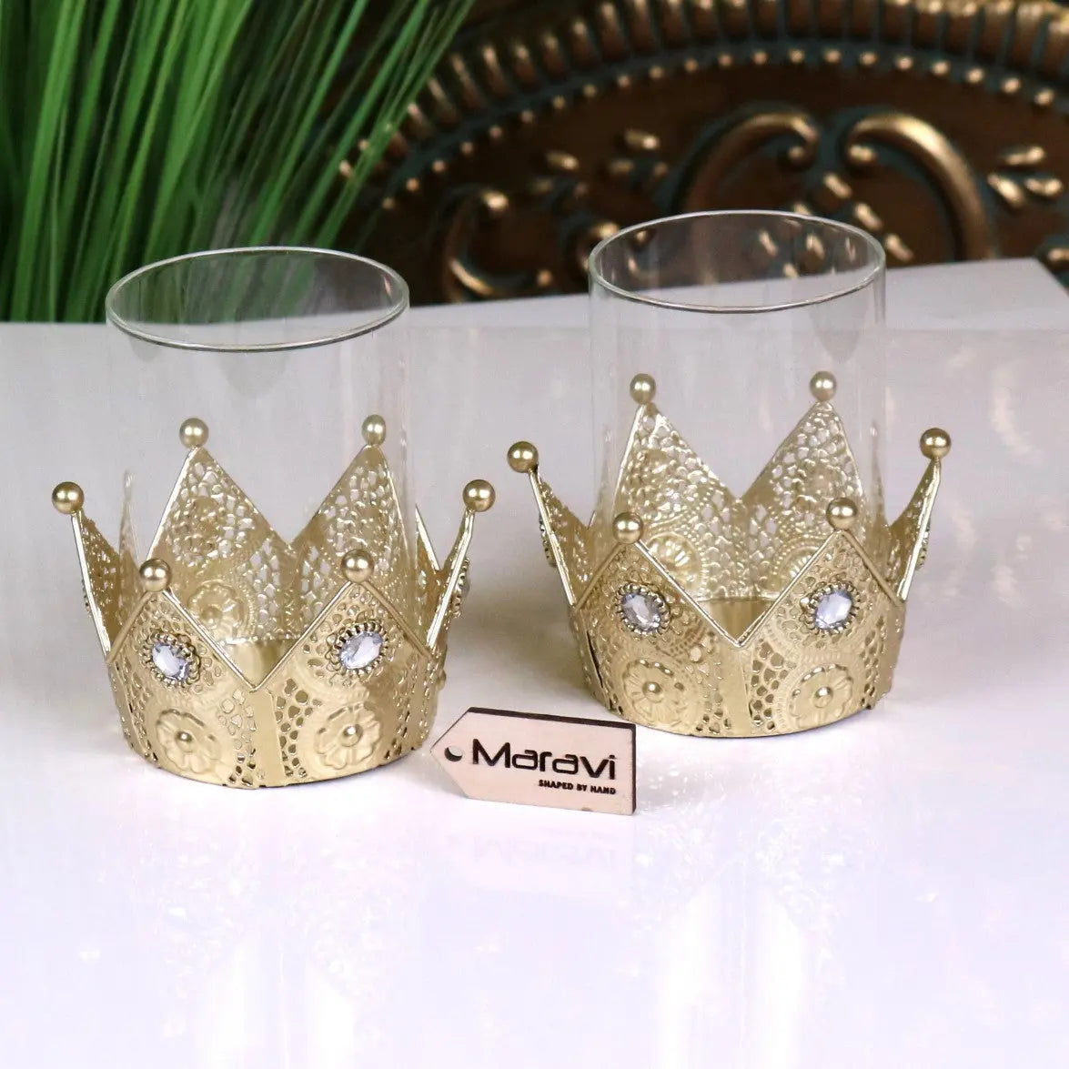 Talika crown candle holder set of 2 features gold crown candle holders with intricate lace patterns and clear gemstones
