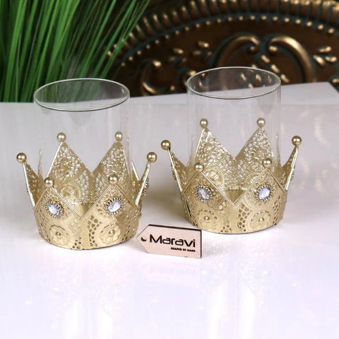 Talika crown candle holder set of 2 features gold crown candle holders with intricate lace patterns and clear gemstones