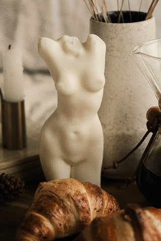 Cream-colored marble tall aphrodite body candle sculpture featuring 1px solid details of a female torso