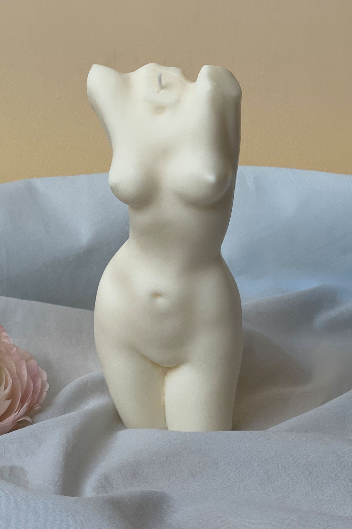 Cream-colored smooth body candle shaped like a female torso with 1px solid details tall aphrodite style