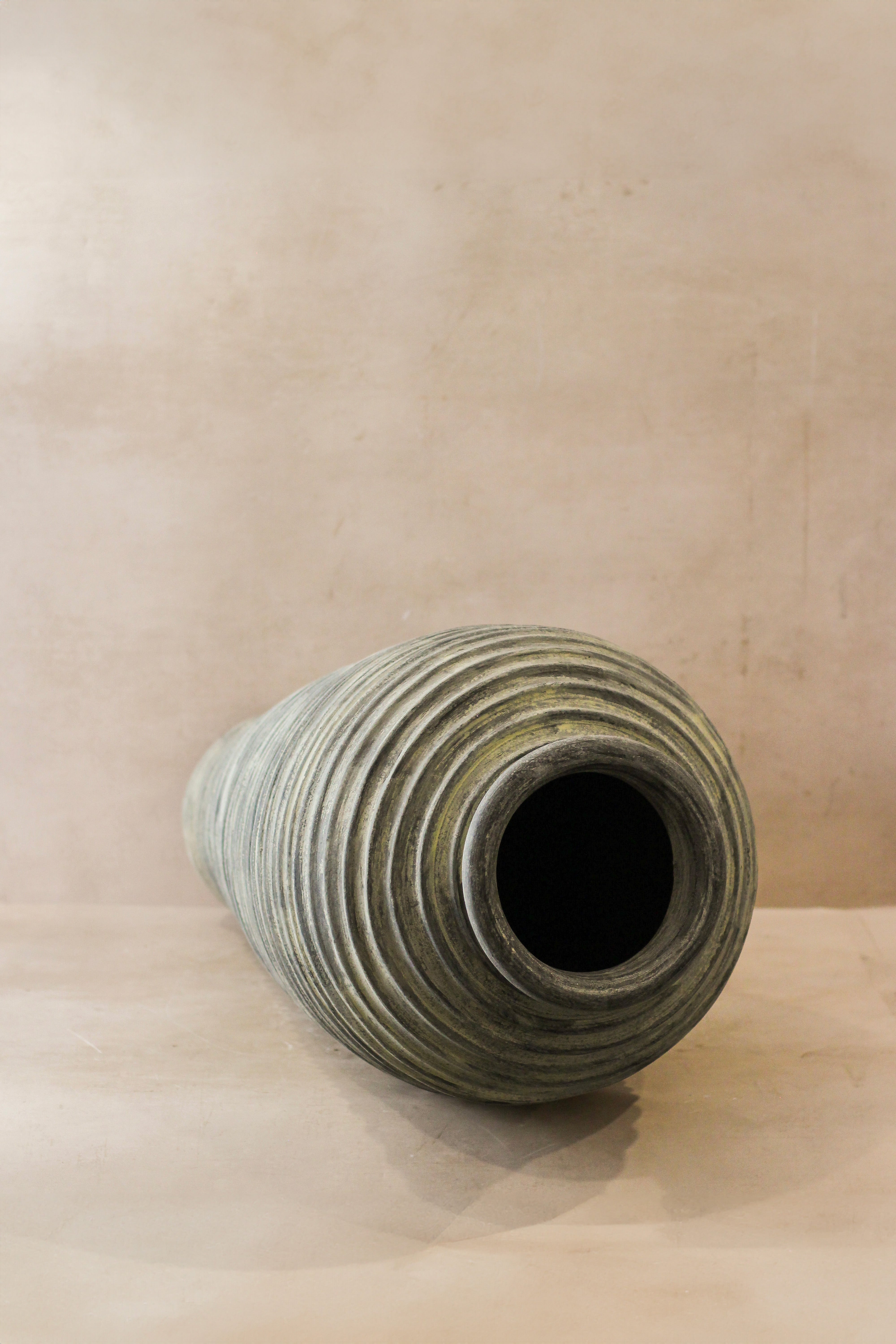 Tall rustic ribbed indonesian pot no 25 xl is a muted green ceramic vase with textured concentric ridges and wide opening