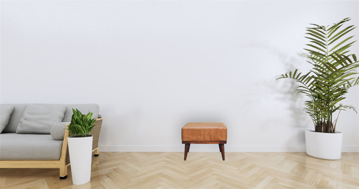 Minimalist wooden footstool with tan buffalo leather top and dark wood legs perfect for cozy seating