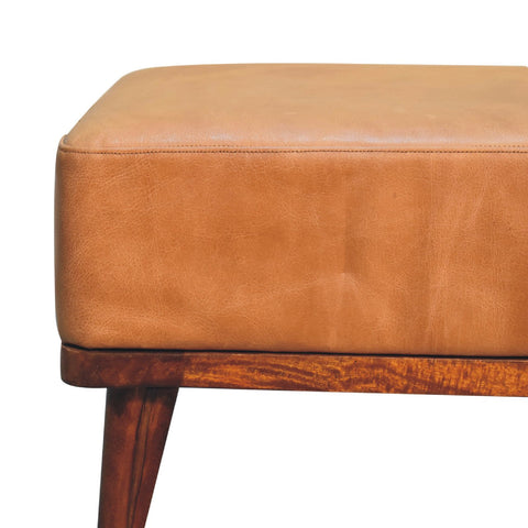 Tan buffalo leather footstool with wooden base and tapered legs perfect for living room seating or footrest