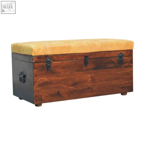 Rustic wooden storage trunk bench with tufted mustard yellow leather top and dark metal latches in tan leather