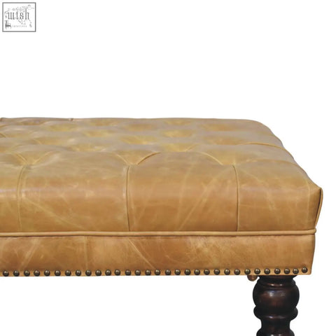 Tan leather upholstered ottoman with tufted bench top brass nailhead trim and dark wood legs