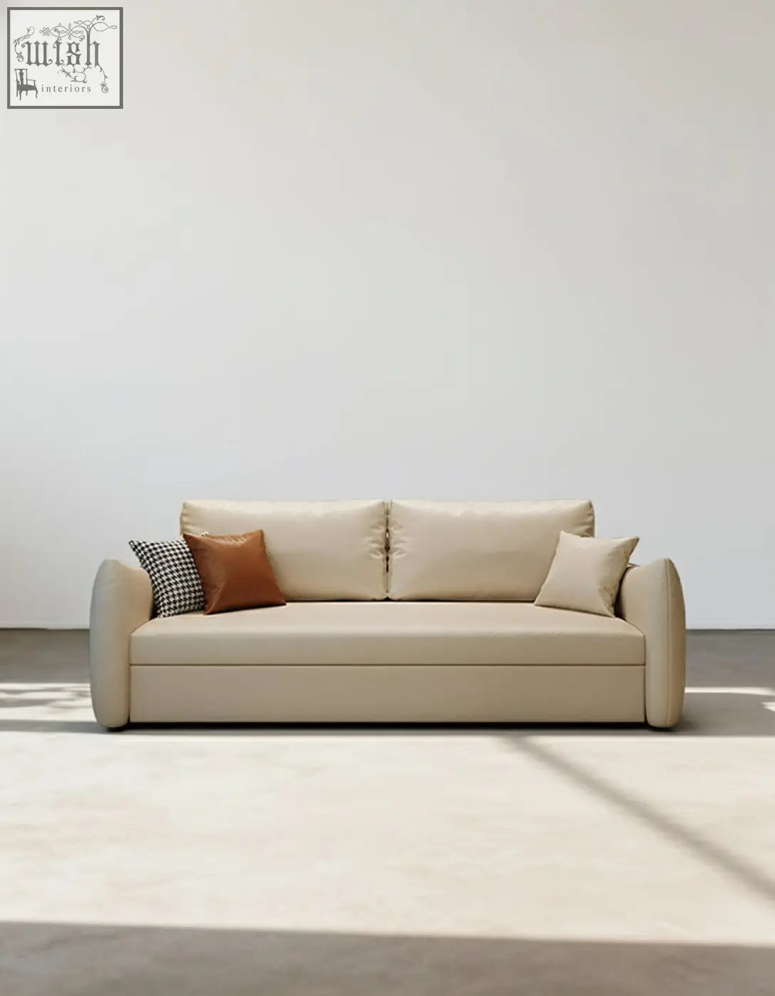 Beige leather tanak two seater sofa bed with rounded arms brown pillow and black and white checkered throw